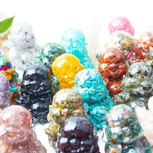 Macro shot of colorful resin Laughing Buddha statues with natural crystal stone fragments