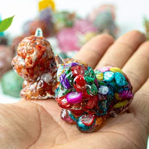 Macro shot of two miniature Highland cow figurines made of colorful resin and crystals