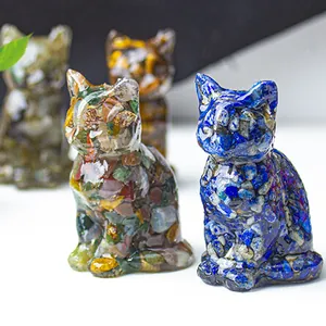 Detailed close-up of resin lucky cat figurines filled with crushed crystals and natural stones