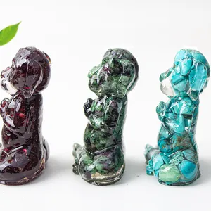Three zen dog figurines with embedded colorful natural gemstones shown in a profile view