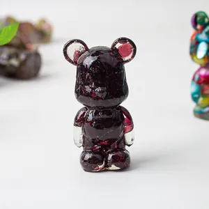 Detail of amethyst crystal resin bear statue with textured stone shards inside the body