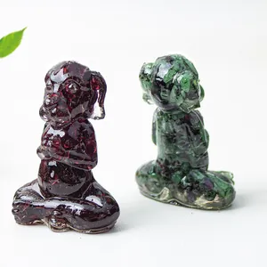 Detail view of mini gemstone dog statues in meditation pose with natural stone textures