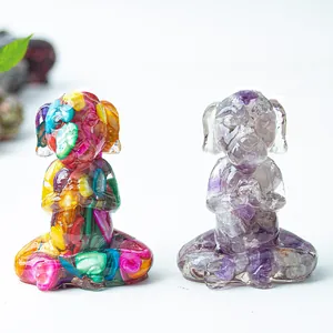 Detail of meditation dog figurines with colorful crystals and amethyst resin insets