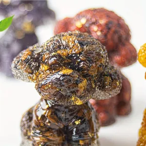 Detail of resin poodle figurine with gold foil flakes and curly fur texture