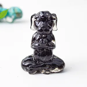 Detailed macro view of a black resin meditation dog statue with polished gemstone finish
