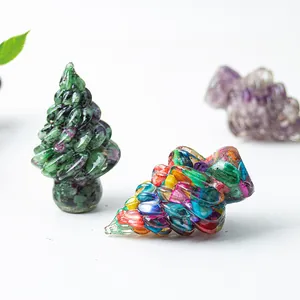 Close-up of hand-carved resin crystal Christmas trees in green and multicolor finishes