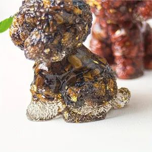 Macro view of crystal teddy dog ornament with tiger eye stones and gold foil