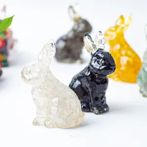 Close-up of cute resin rabbit statues with crushed crystal stones in various colors