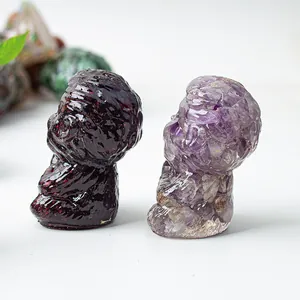 Macro shot of red garnet and purple amethyst stones carved in artistic facial profile