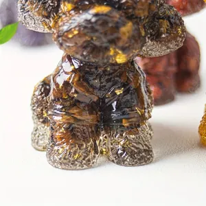 Teddy dog figurine made of clear resin with tiger eye crystal and gold foil flakes