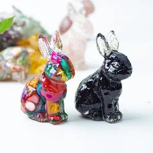 Close-up of crystal resin rabbit figurines with colorful mosaic and glossy black finish