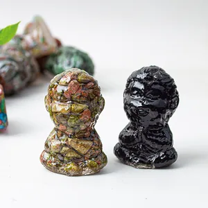 Close-up of resin crystal monkey figurines in meditation pose for zen desktop decor