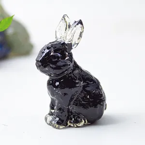 Detail view of rabbit resin ornament with black body and transparent crystal ears
