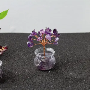 Macro shot of handcrafted amethyst crystal tree with wire trunk in glass vase
