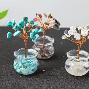 Detail of handcrafted gemstone money tree with crystal leaves and glass base decor