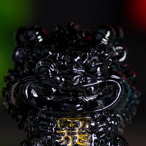 Polished black crystal guardian lion statue with gold plated character pendant