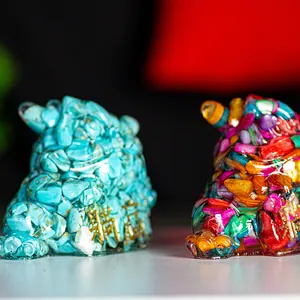 Detail of resin fortune toad statues filled with turquoise and colorful crystals
