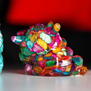Macro shot of colorful resin bear figurine with crystal shell textures and glossy finish