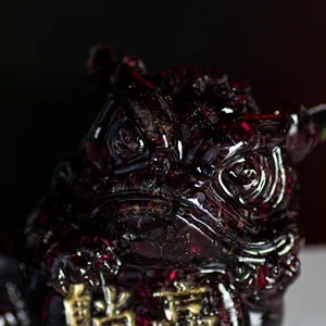 Three-legged golden toad resin sculpture with natural red crystal texture and gold details