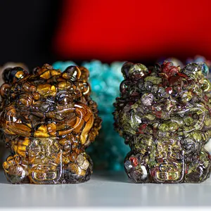 Detailed close-up of lucky Pi Xiu statues made with natural tiger eye and green crystal stones