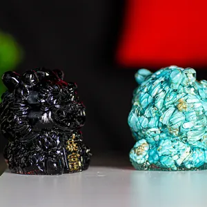 Macro detail of lion figurines in black obsidian and turquoise with golden engraving