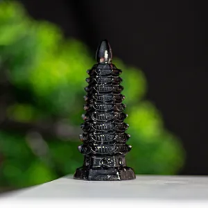 Detailed close-up of a 9-layer black obsidian crystal Wen Chang Pagoda for desk decor
