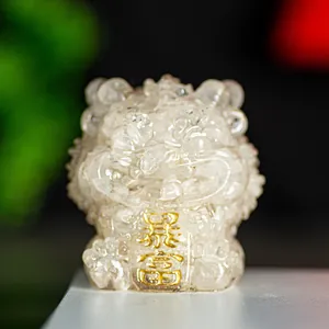 Close-up of translucent crystal guardian lion statue with gold Fortune plaque detail