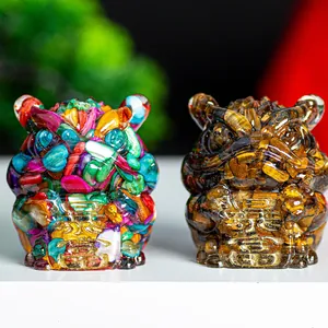 Detailed view of two resin three-legged toads with natural crystals and gold fortune relief