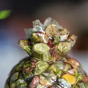 Macro view of crystal resin pineapple leaf crown with colorful gemstone textures
