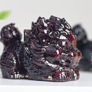 Macro detail of a translucent dark red resin dragon turtle ornament with fine carving