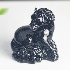 Detailed close-up of a glossy black horse statue with traditional carved cloud base