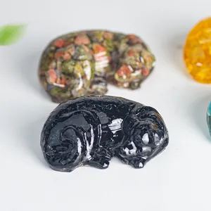 Macro shot of sleeping labrador resin figurines with colorful natural stone infills