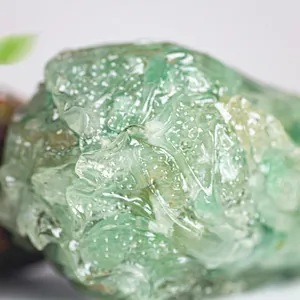 Macro shot of natural green crystal cabbage ornament showing detailed texture and translucency