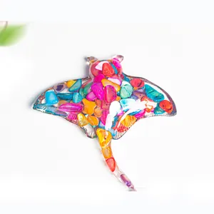 Translucent resin manta ray sculpture filled with vibrant colorful natural crystals