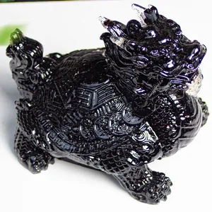 Detail of black resin dragon turtle statue featuring intricate back patterns and coin carvings