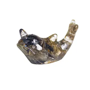 Miniature resin narwhal sculpture with natural crystal textures on white background