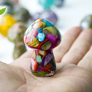 Close-up of a miniature resin mushroom figurine filled with colorful natural crystals