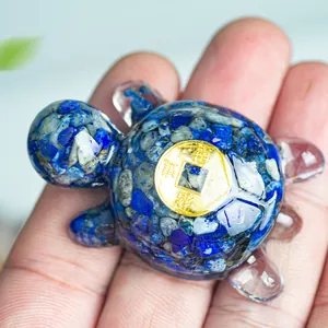 Macro shot showing blue crystal resin turtle sculpture size compared to human hand