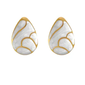 Minimalist gold teardrop earrings with white marble enamel inlay on white background