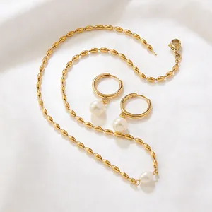 Exquis collier de perles dorées et boucles d'oreilles créoles sur soie blanche