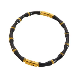 Bambus Armband aus Edelstahl mit schwarzer Emaille und eleganten goldenen Gliedern