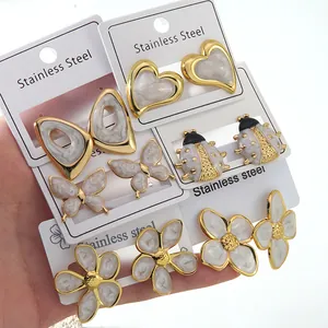 Macro detail of assorted stainless steel stud earrings with enamel heart and floral designs