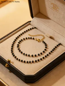 Detail of beaded necklace with gold lobster clasp and adjustable extension chain