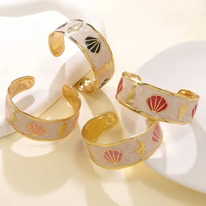 Dettaglio di quattro bracciali smaltati colorati con motivi di cavallucci marini e conchiglie