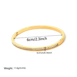 Detailed view of gold bangle width and diameter measurements with crystal inlay