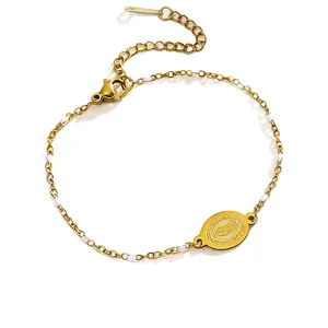 Bracelet en acier inoxydable doré avec perles émaillées blanches et pendentif religieux