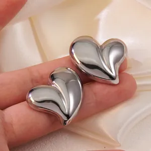 Polished silver heart-shaped stud earrings in a minimalist irregular 3D design