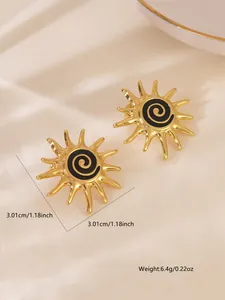 Detail view of gold sunburst earrings with black spiral enamel and size measurements