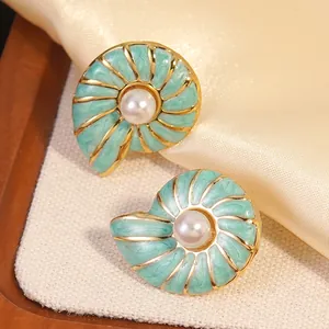 Golden sea shell earrings with green enamel and white pearl accents in a vintage style
