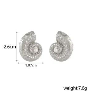 Detailed view of silver spiral conch earrings with white pearls and 2.6cm dimensions